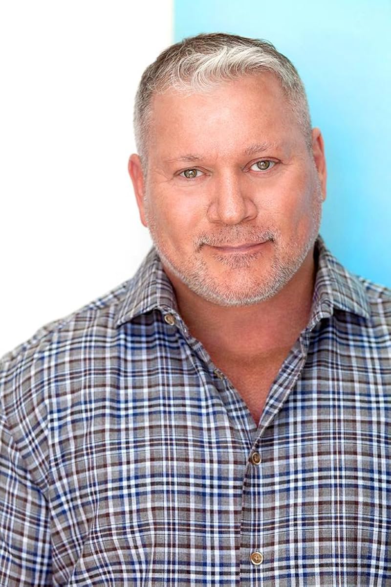Benjamin Poe — headshot in plaid shirt